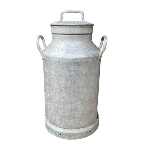 A vintage galvanized metal milk canister with a lid, featuring two side handles and a top handle, shown against a plain white background.