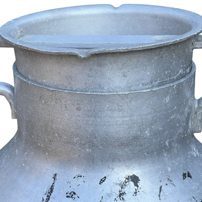 Close up of a Vintage French aluminium milk churn with a lid on a white background