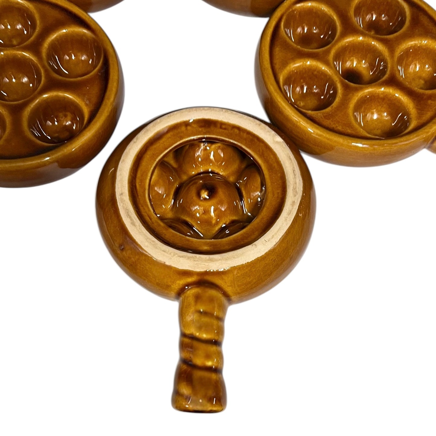 set of 5 amber brown coloured 6 hole snail plates on a white background 