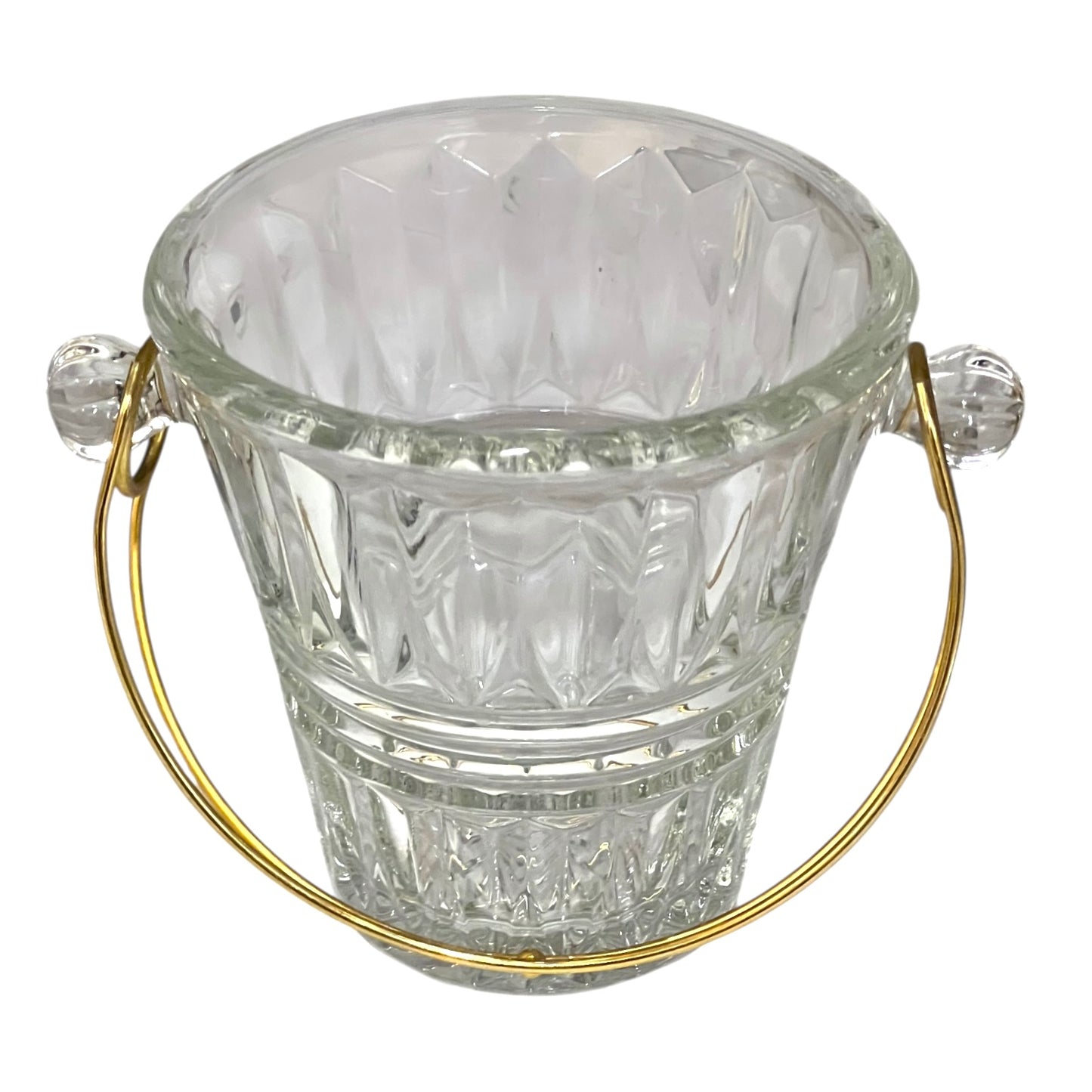 Clear glass ice bucket with gold handle on a white background