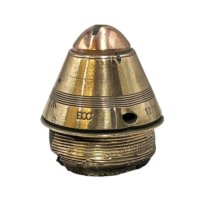 Polished British brass WW1 fuse or paperweight type 101 on a white background