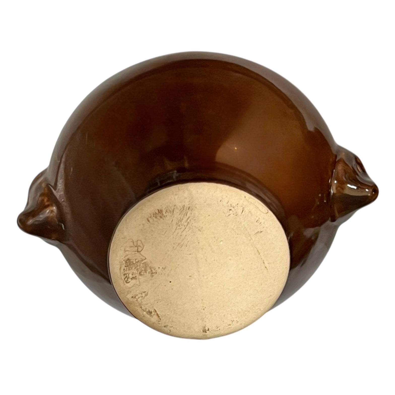 Brown ceramic bowl with decorative lion head handles on a white background