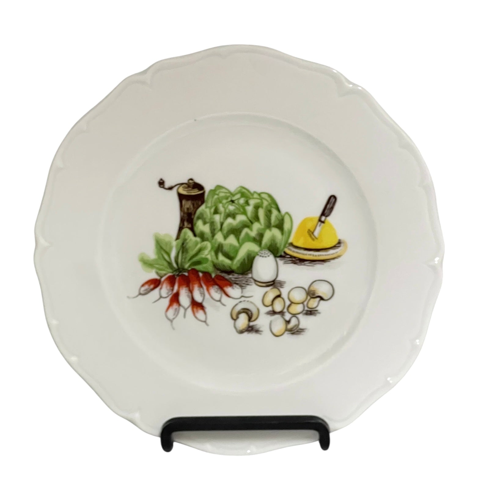Porcelain plate with decorative salad vegetable illustrations on a white background