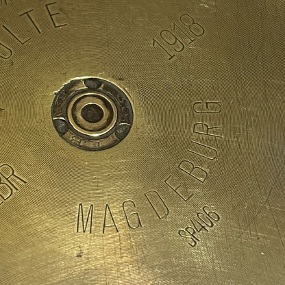 Close up of a brass WW1 German shell case on a white background