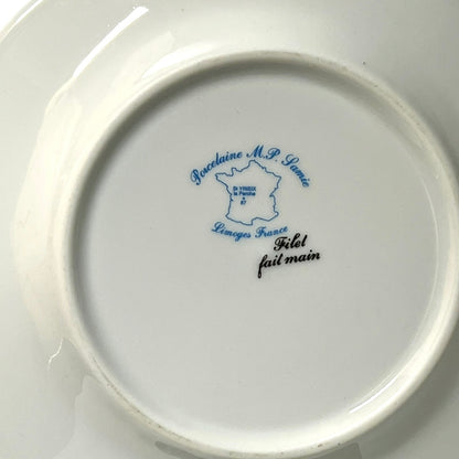 Ceramic plate with blue and black text on a white background