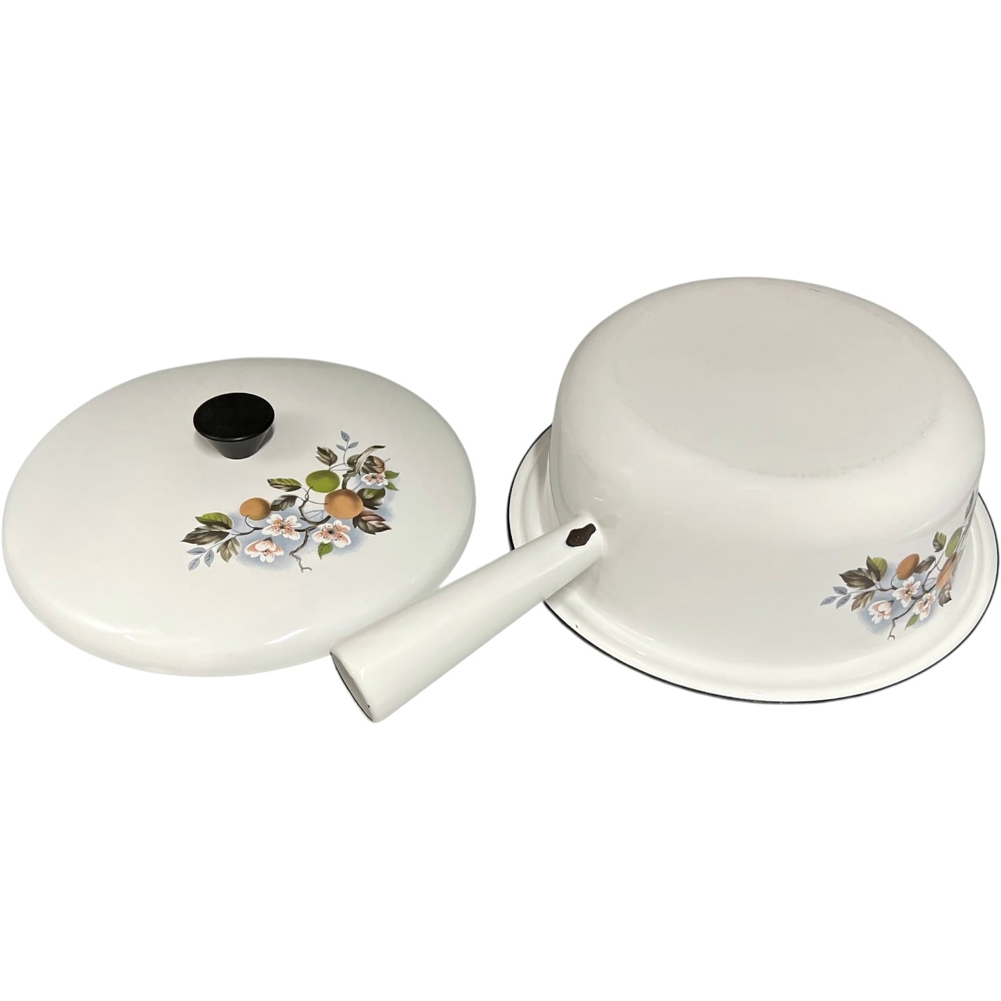 White enamel saucepan and lid with floral design on a white background