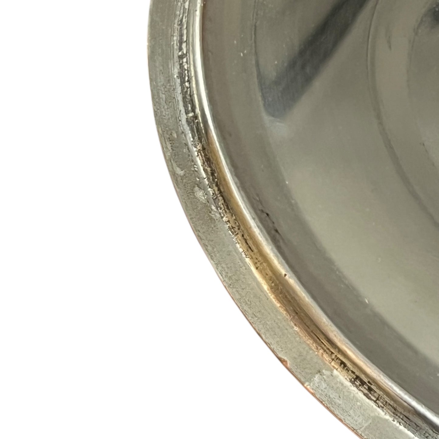 Close-up of a copper pan lid  with a reflective surface on a white background