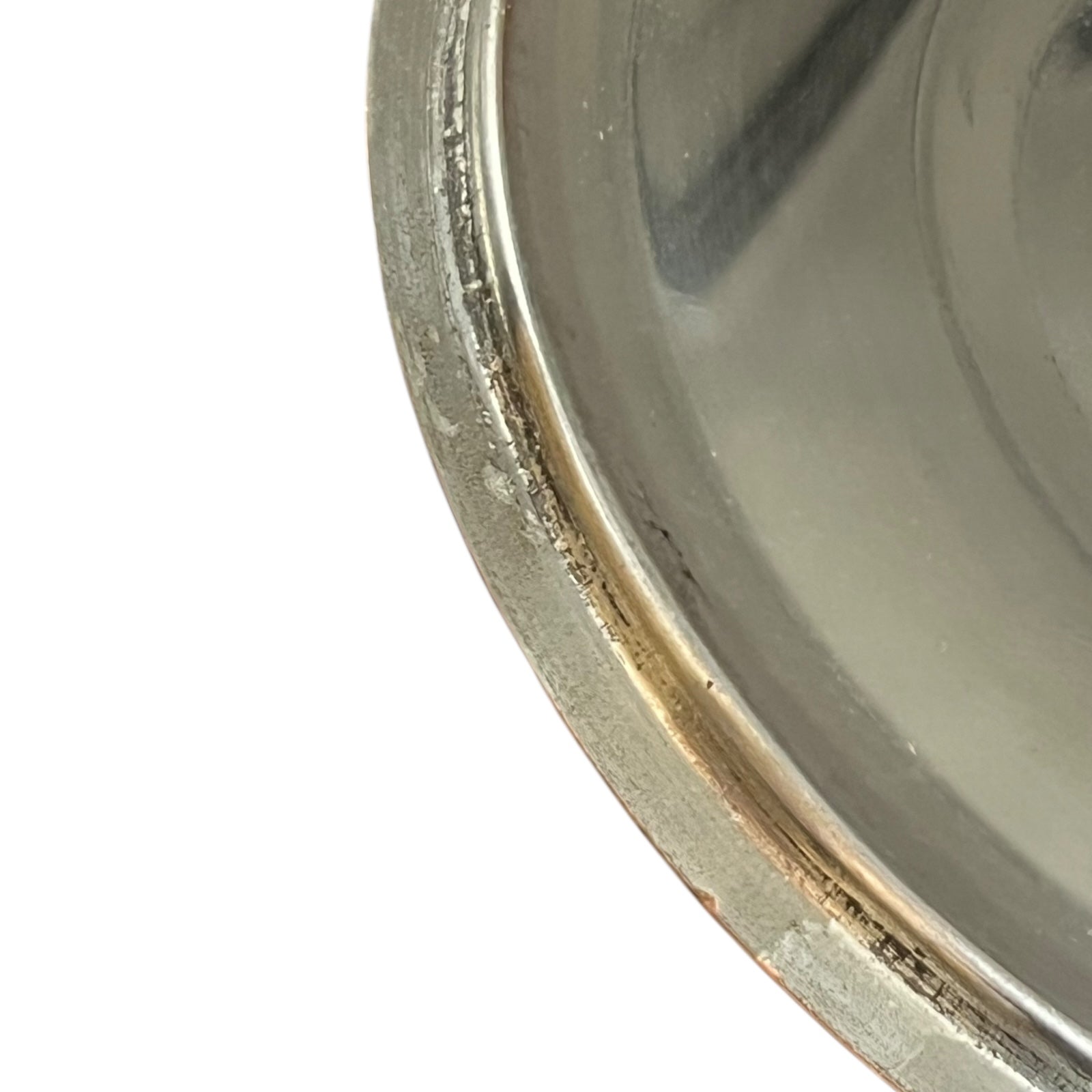 Close-up of a copper pan lid  with a reflective surface on a white background