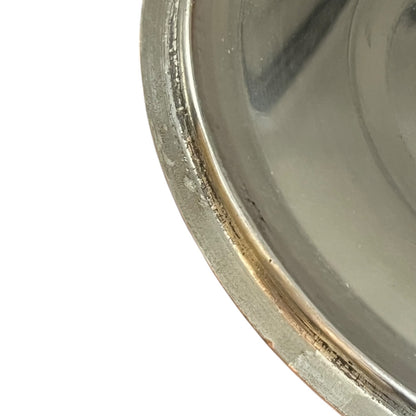 Close-up of a copper pan lid  with a reflective surface on a white background