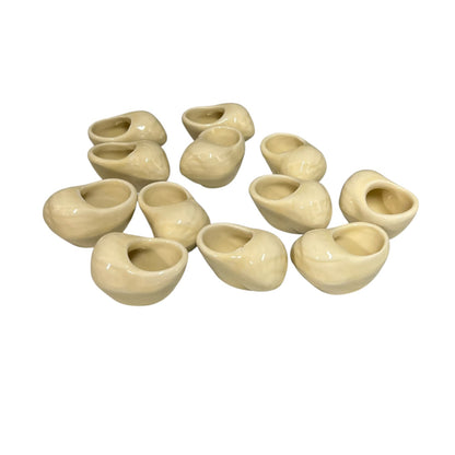 Set of 12 ceramic French escargot cups shaped like snails ideal for a restaurant or a keen French cook, set on a white background