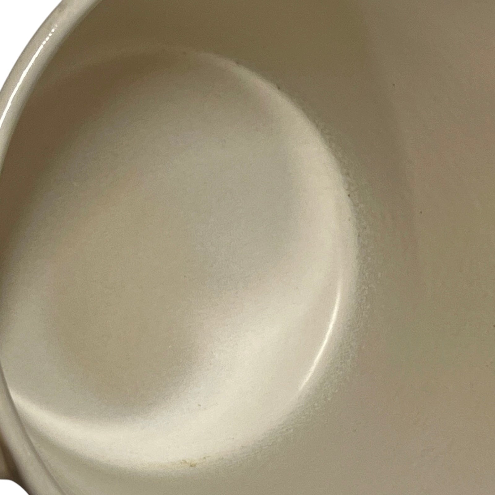 Inside view of a vintage Le Creuset saucepan on a plain white background 