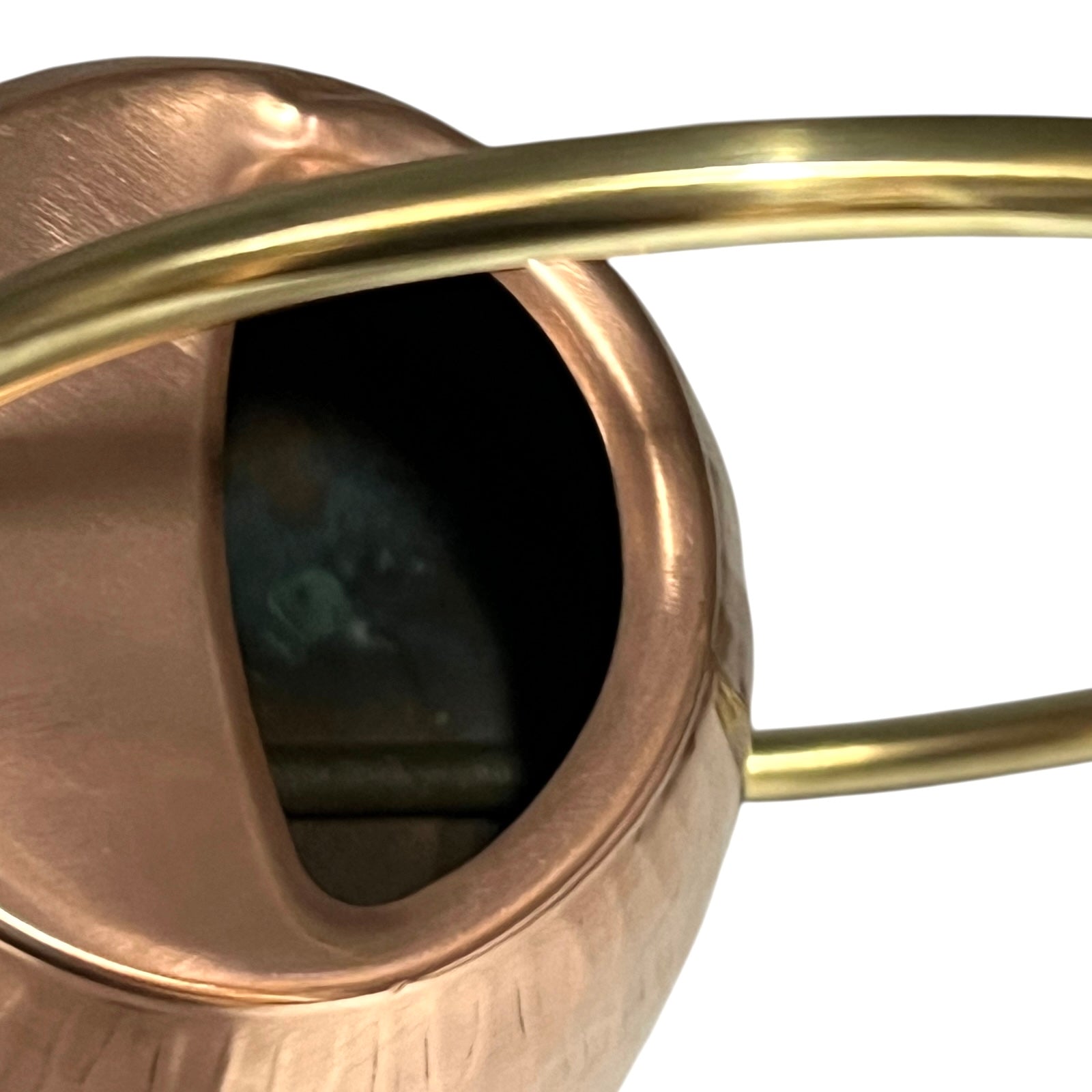 Close up of copper and brass watering can on a white background