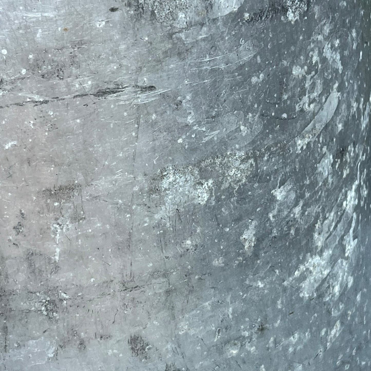 Close up of a Vintage French aluminium milk churn with a lid on a white background