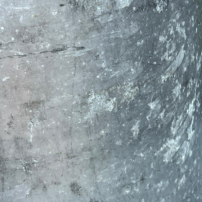 Close up of a Vintage French aluminium milk churn with a lid on a white background