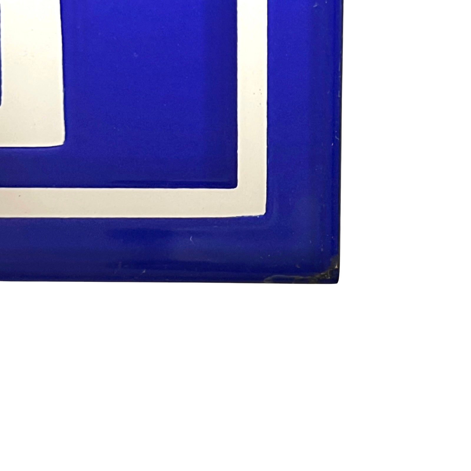 A close-up of a glossy cobalt blue decorative panel with a white border, shown against a plain white background.