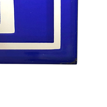 A close-up of a glossy cobalt blue decorative panel with a white border, shown against a plain white background.