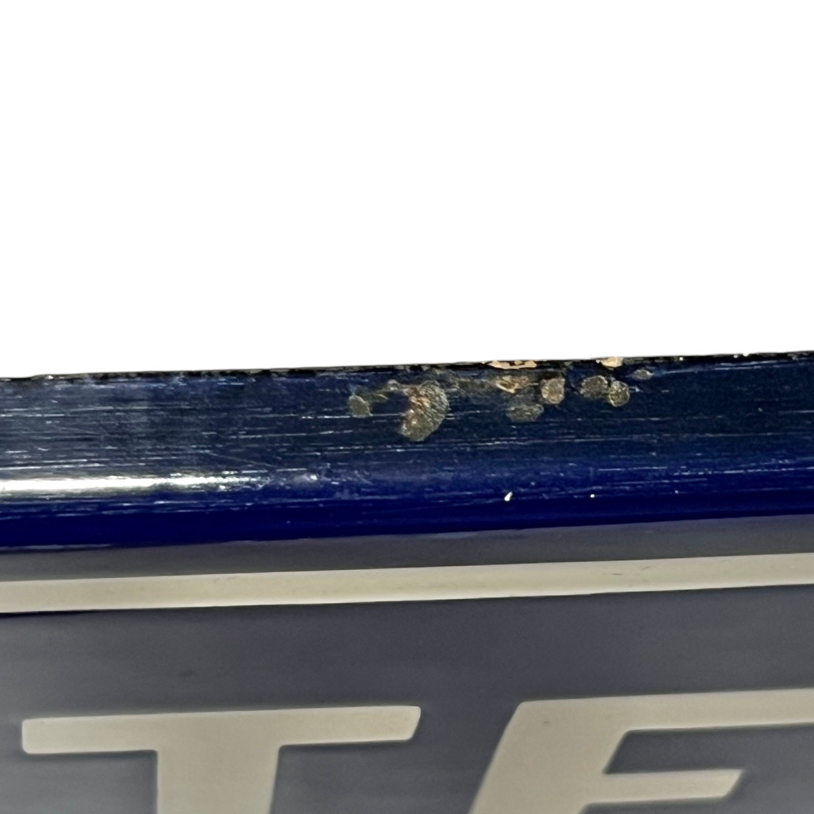 Close-up of a blue and white sign  on a white background