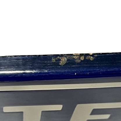 Close-up of a blue and white sign  on a white background