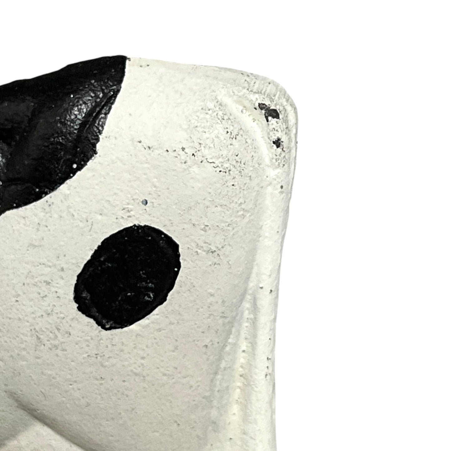 Close-up of a cow toilet roll holder on a white background
