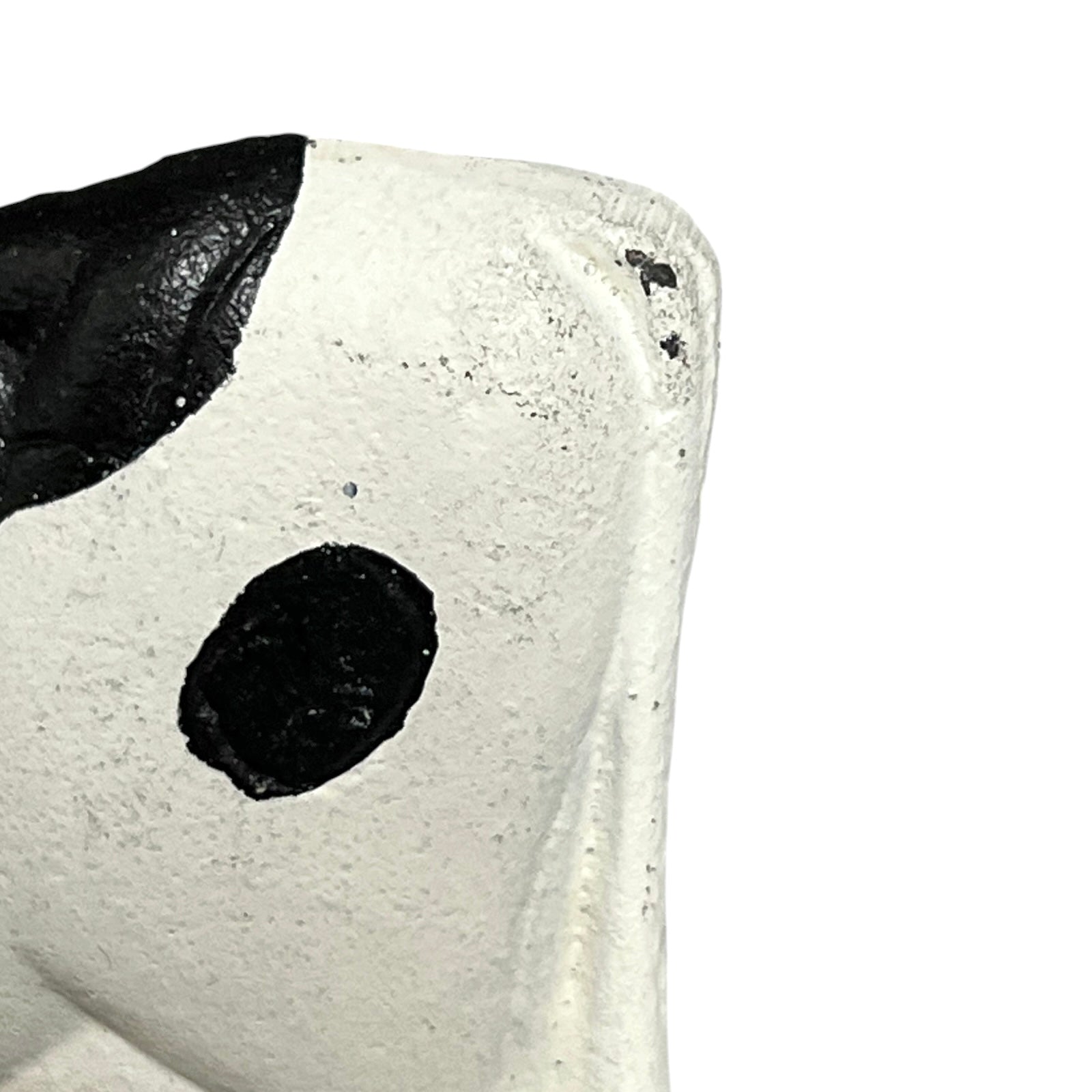 Close-up of a cow toilet roll holder on a white background