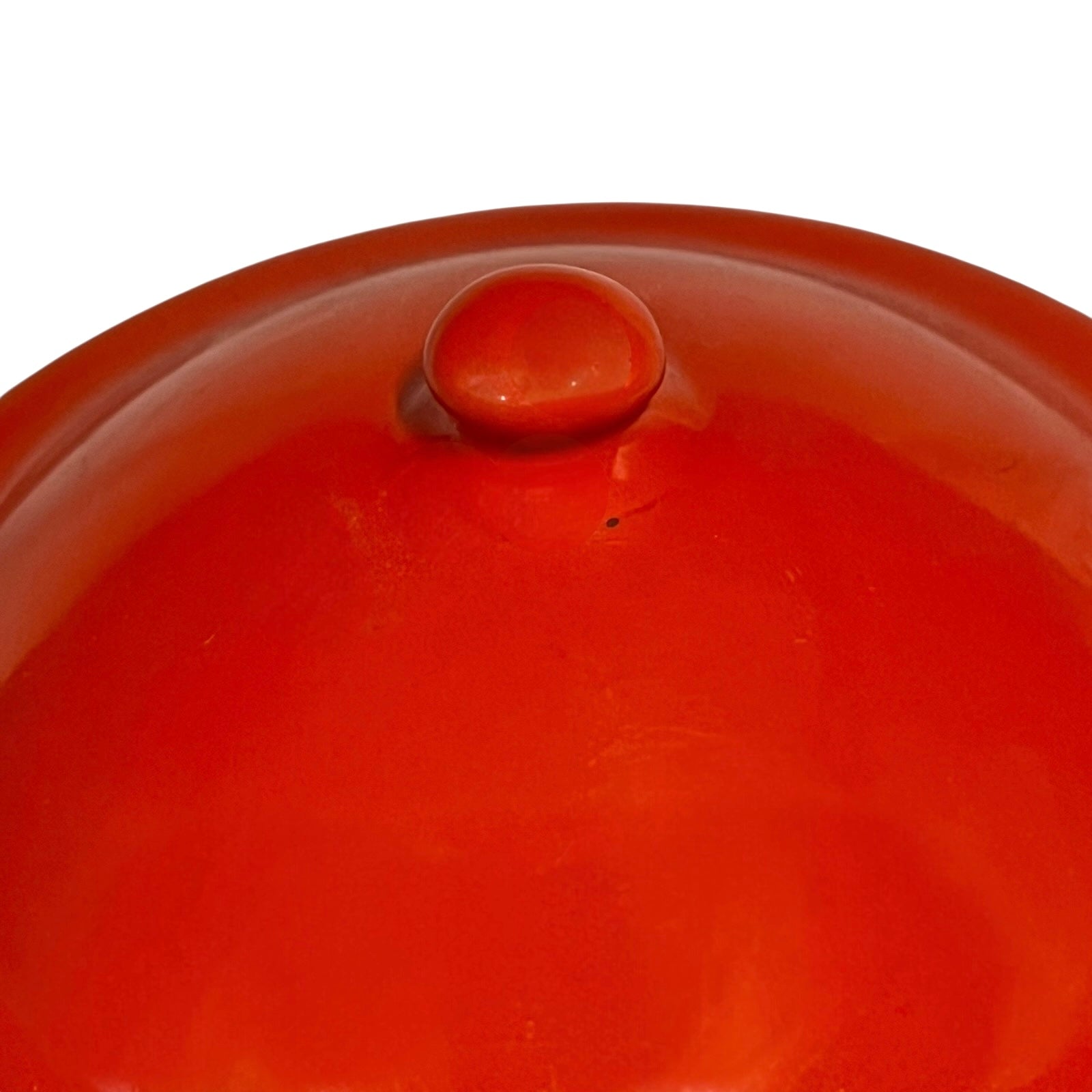 Close up of a red vintage French enamelled coffee pot on a white background