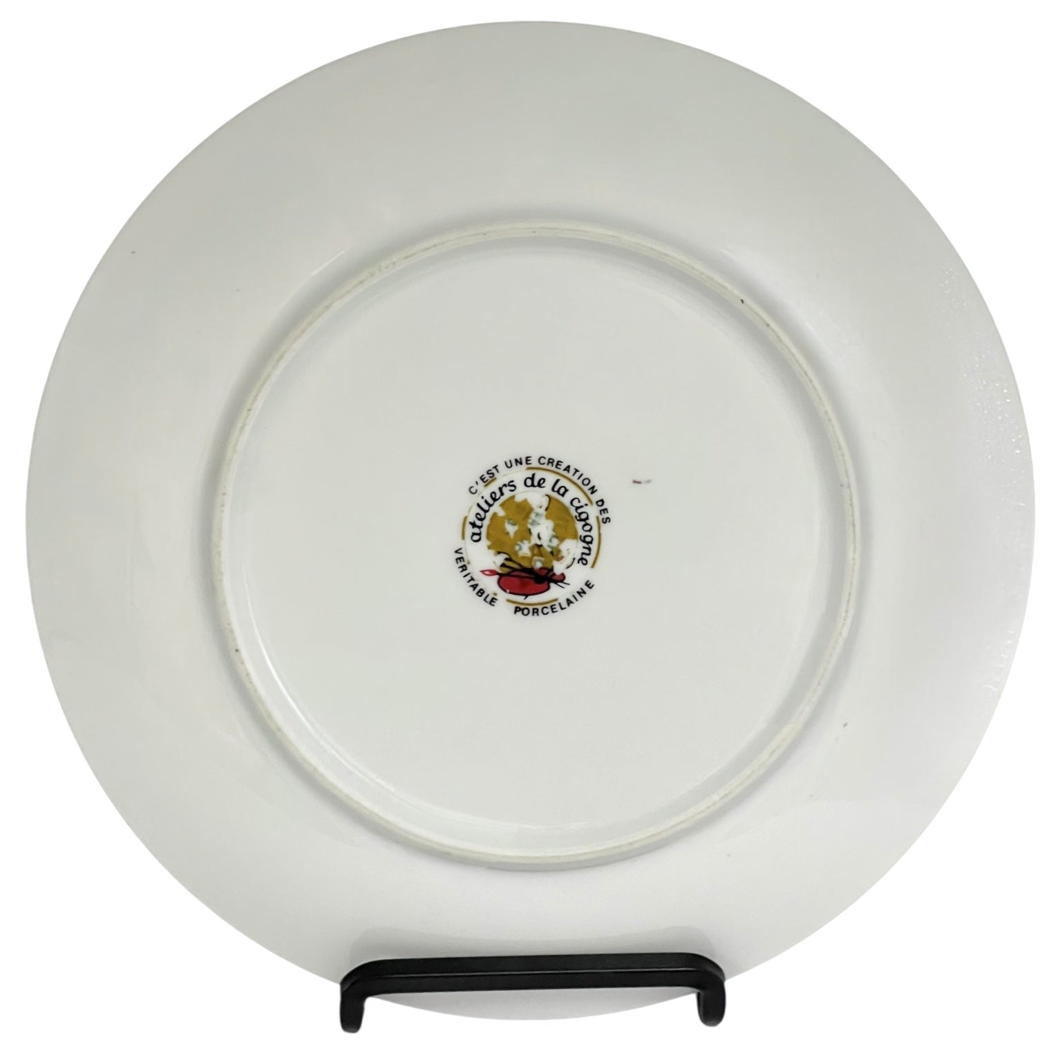 White plate with a logo and text on a stand against a white background
