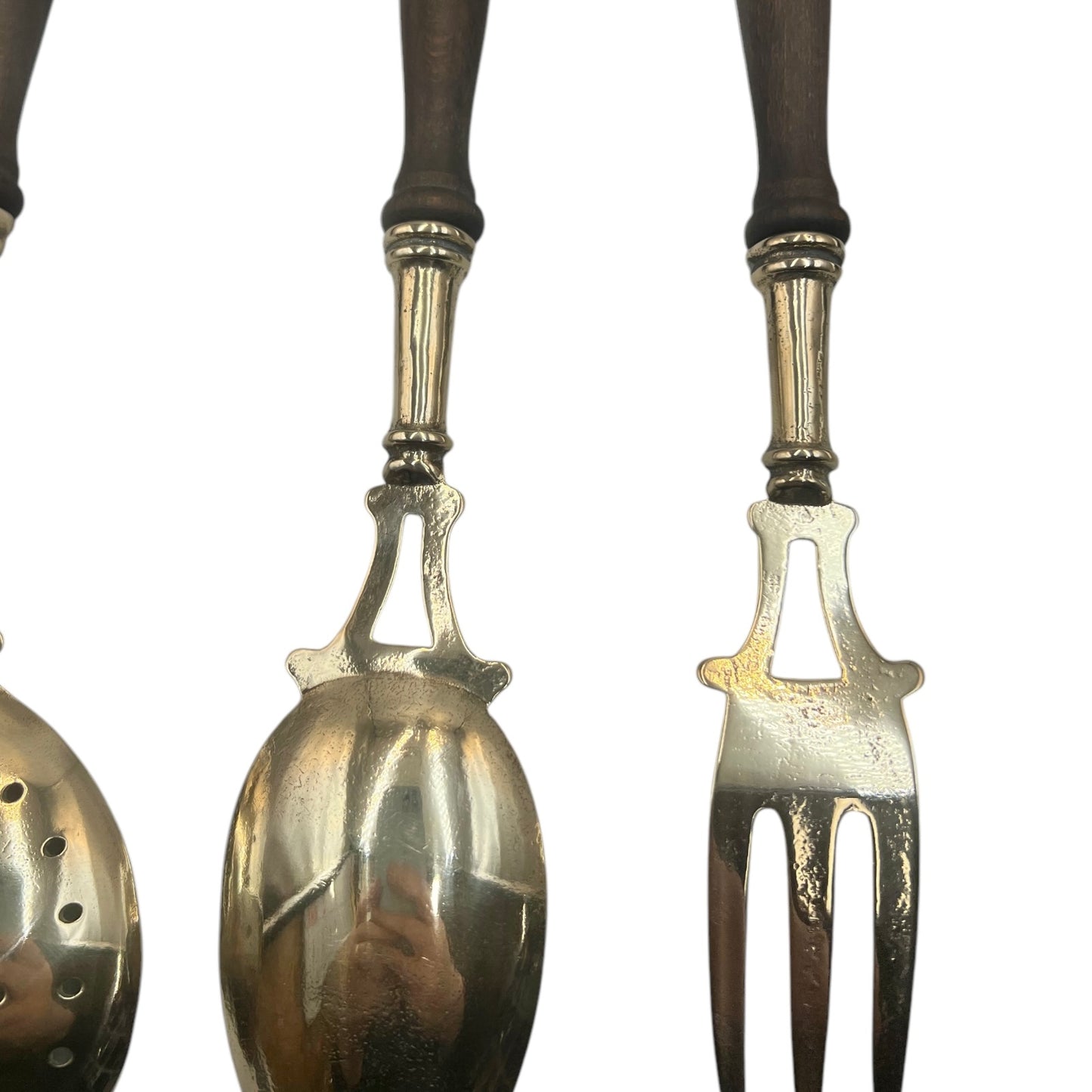 French brass and wooden 4 piece utensil set hanging from a brass bar