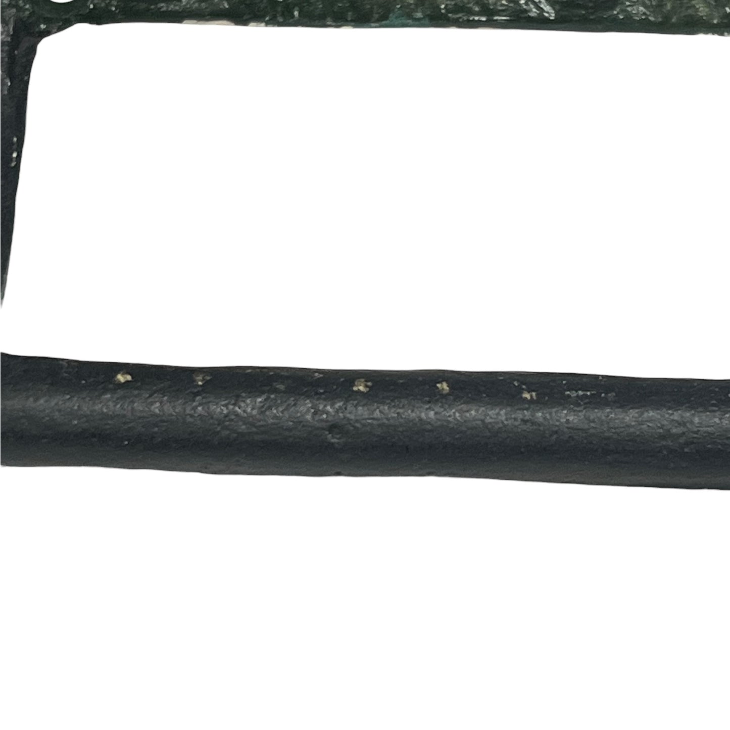 A close-up of a black textured cylindrical product, likely a strap, trim, or cable, with a white background.
