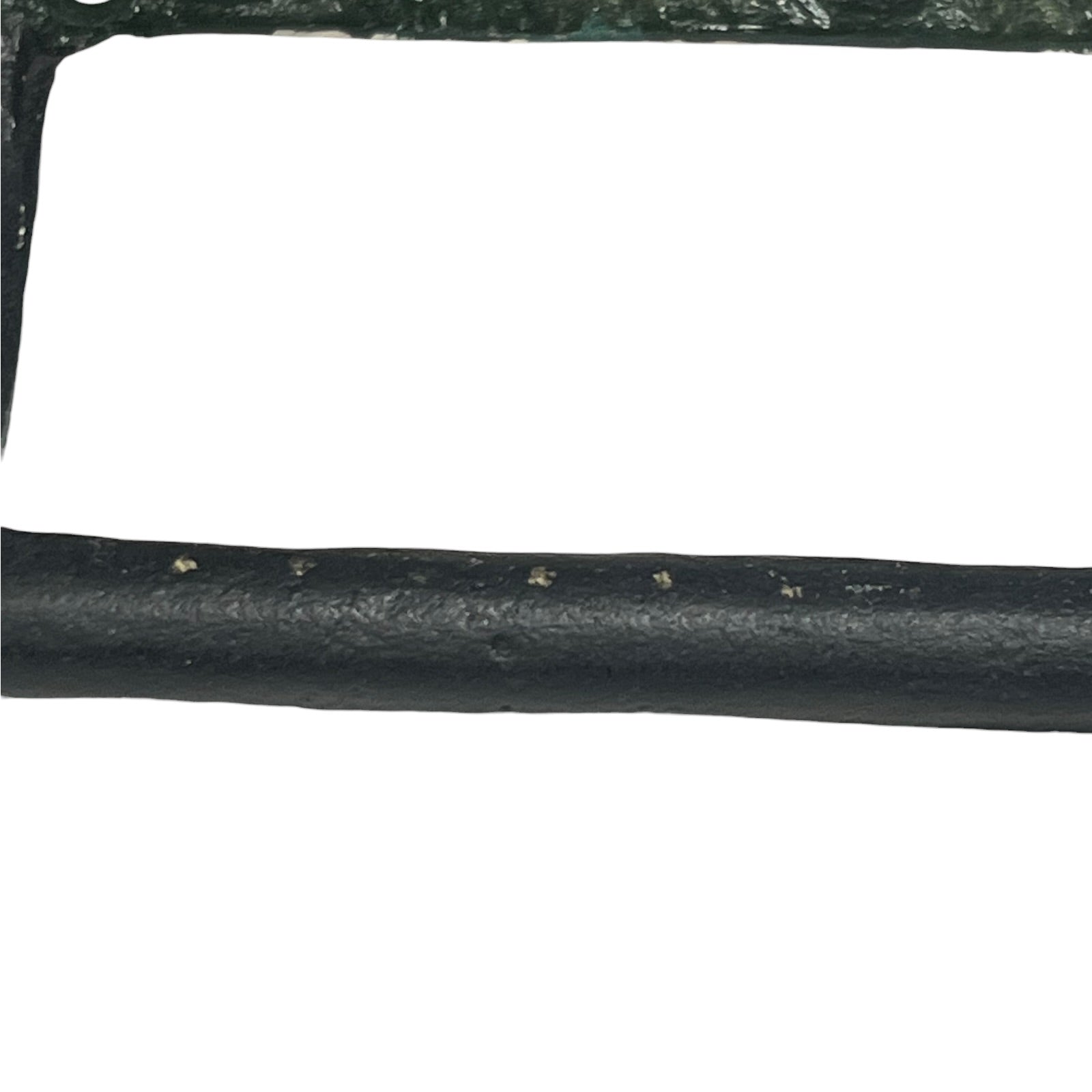 A close-up of a black textured cylindrical product, likely a strap, trim, or cable, with a white background.