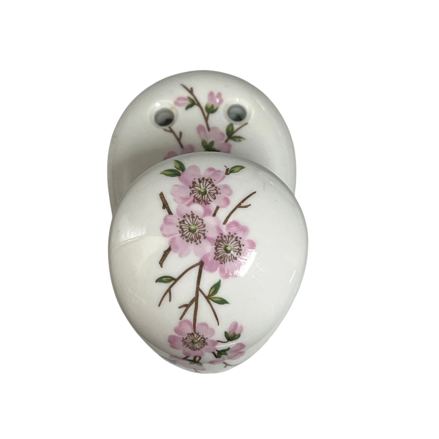 Two round white ceramic cabinet knobs decorated with a pink floral branch pattern, shown on a plain white background.