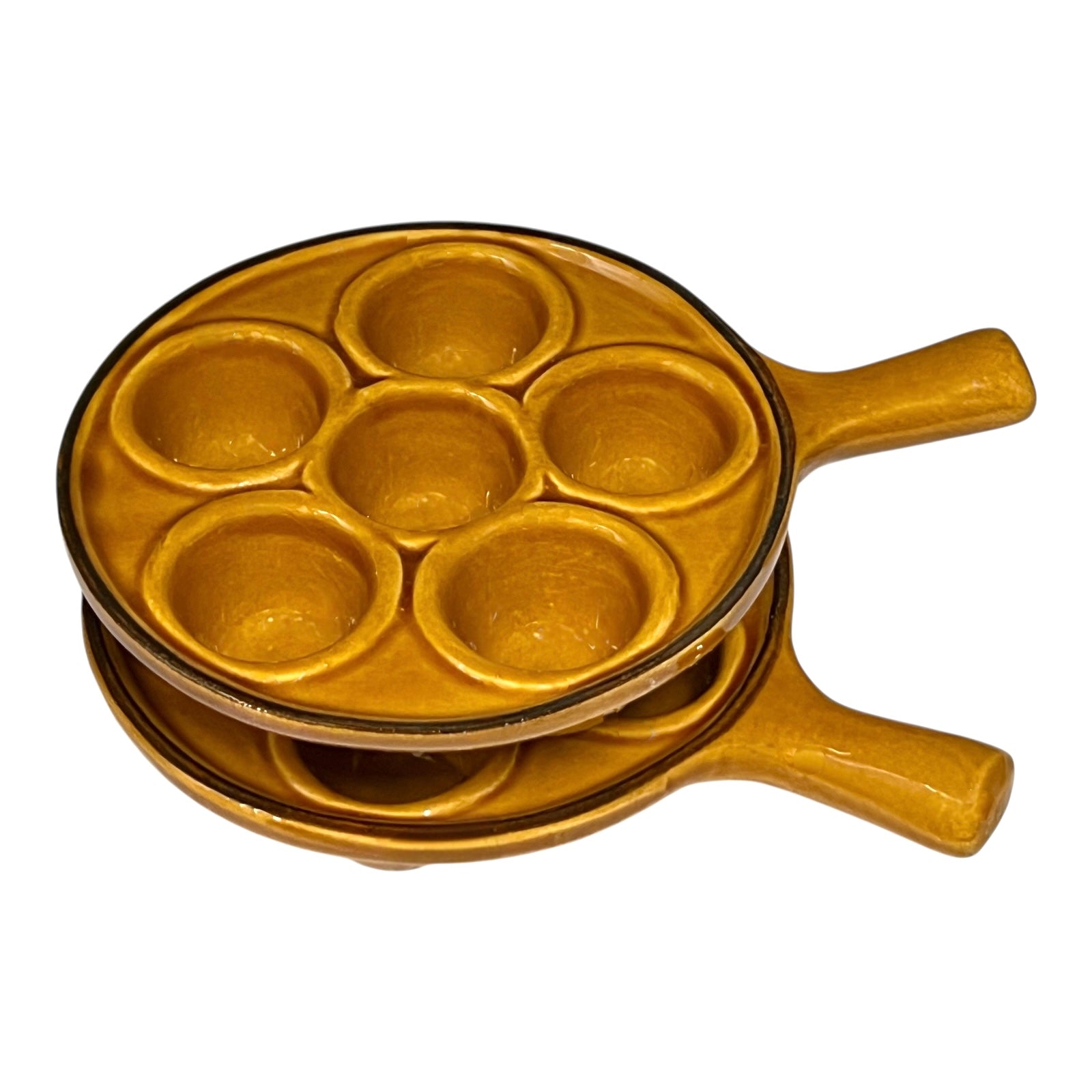 pair of amber-coloured French ceramic escargots plates with handles on a white background