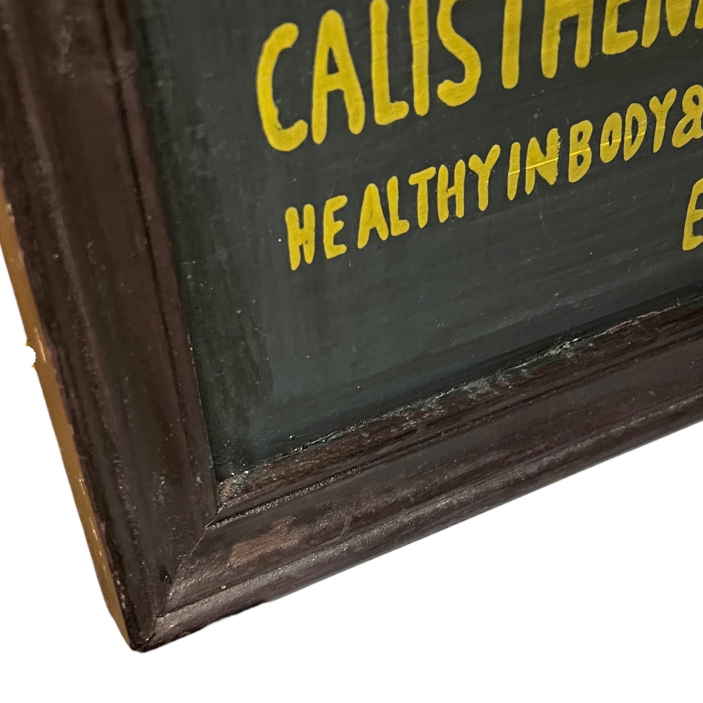 Corner of a framed picture with a dark brown frame and green interior.