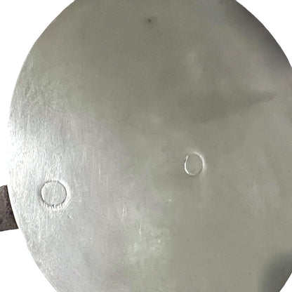 Close up French copper pan lid showing hand wiped traditional new tin lining  on a white background