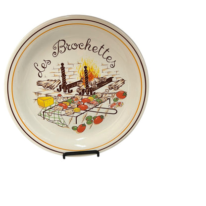 Decorative plate with a grill scene and 'Les Brochettes' text on a white background