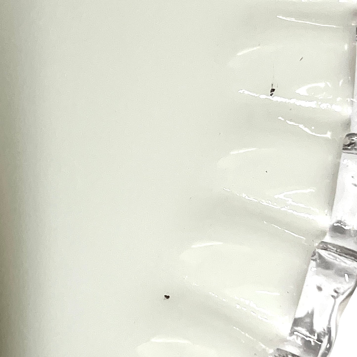close up of white glass lampshade with a pleated edge