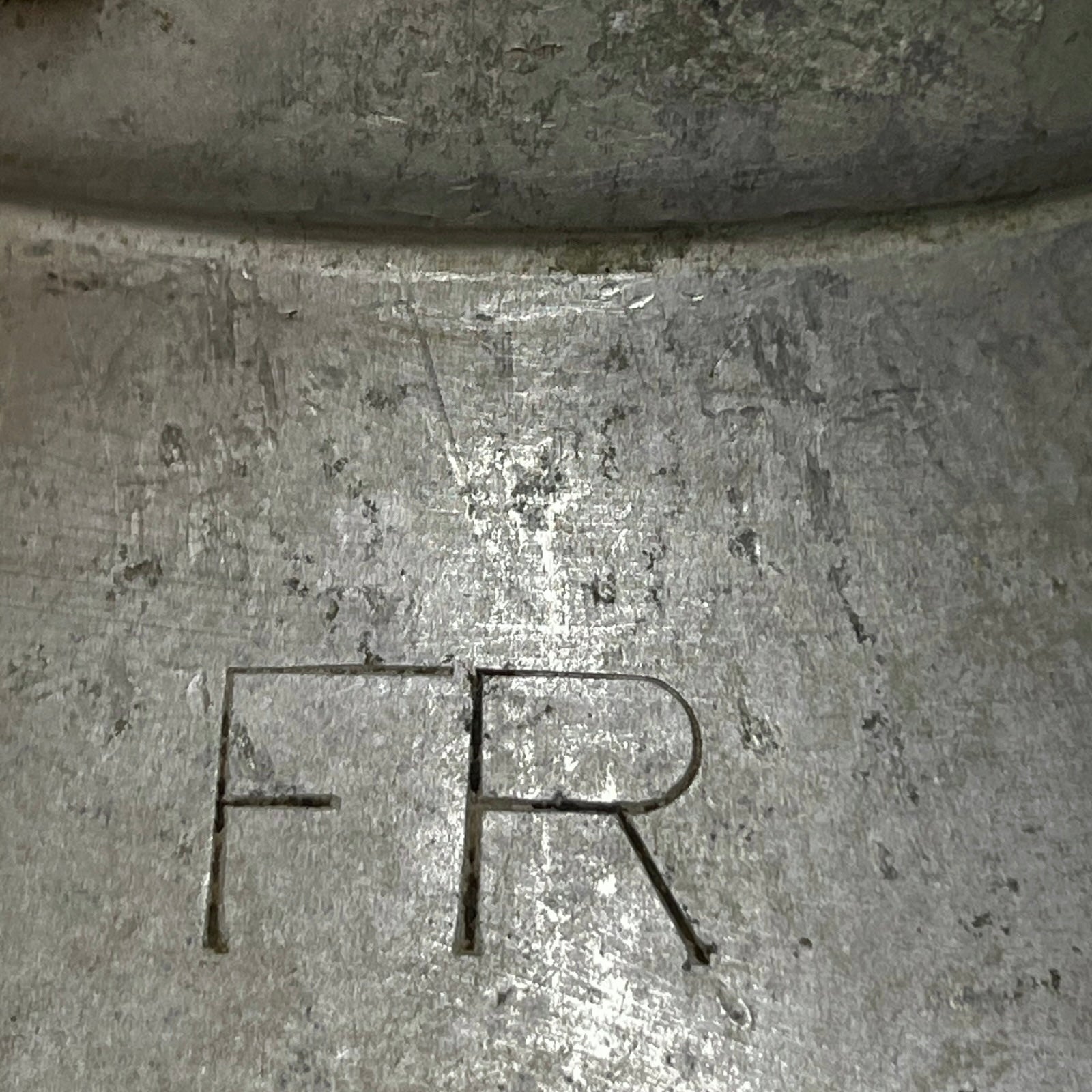Close up of a vintage metal milk churn on a white background