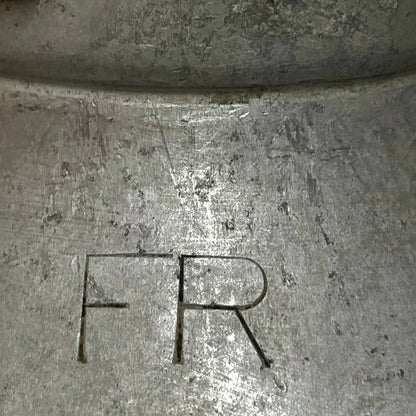 Close up of a vintage metal milk churn on a white background