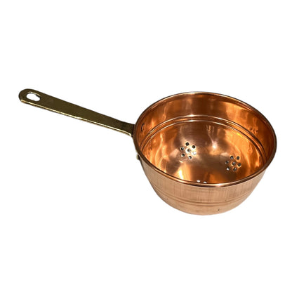 Small copper French sieve with a brass handle on a white background