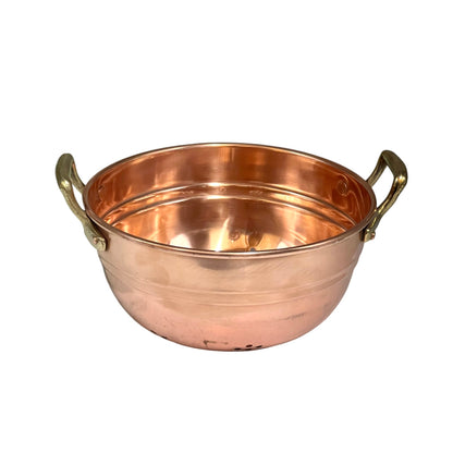 Small copper colander with brass handles on a white background 