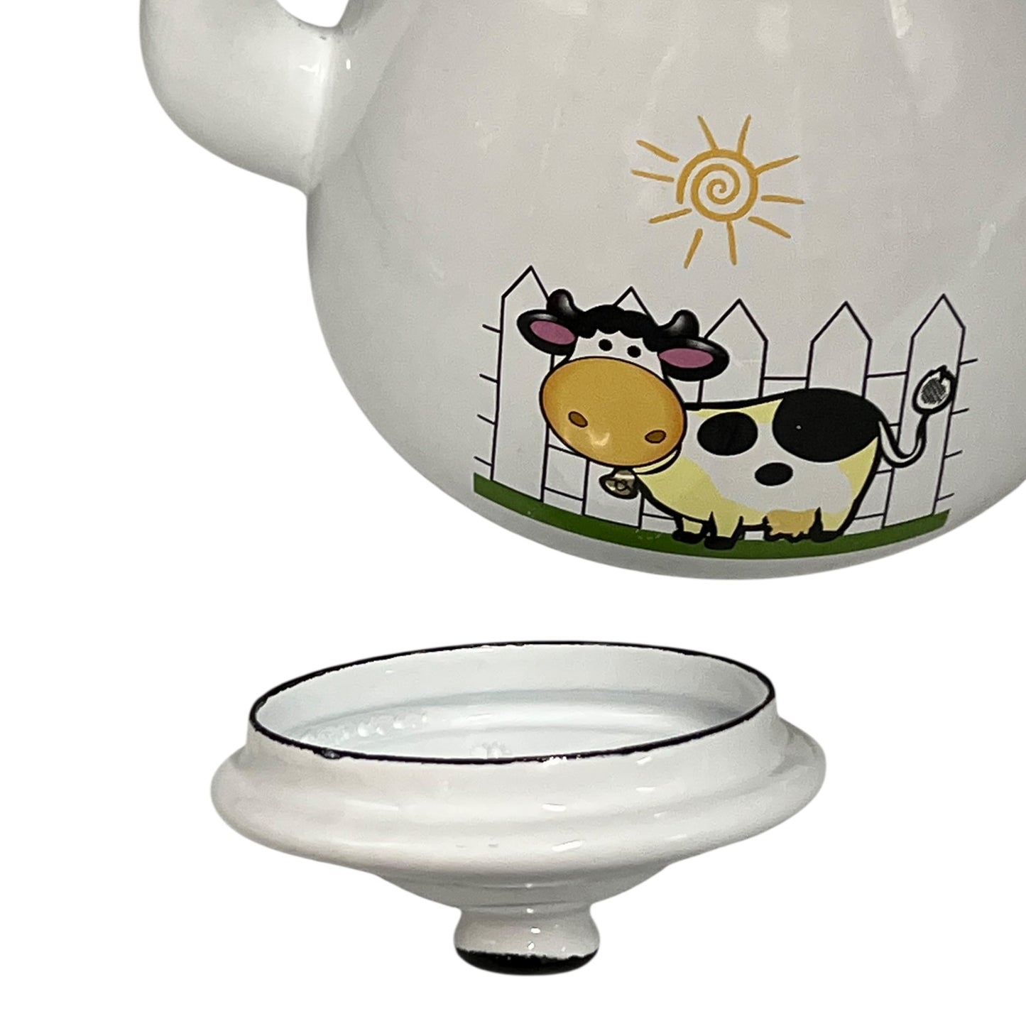Enamel tea pot with a cow illustration on a white background