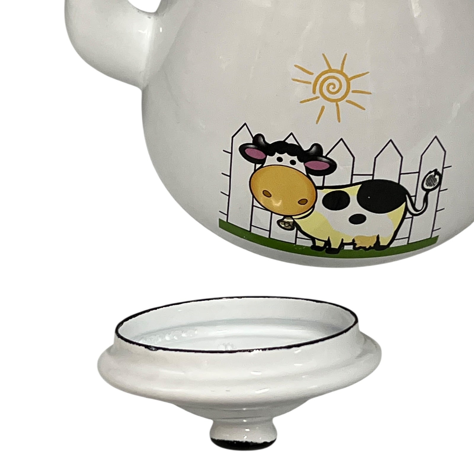Enamel tea pot with a cow illustration on a white background