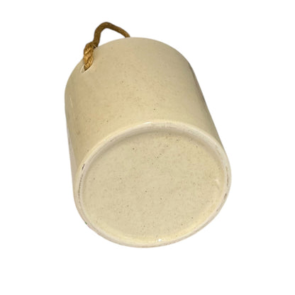 A small cylindrical ceramic hanging ornament in a warm cream or off-white glaze, with a small loop at the top for hanging. The item is photographed on a plain white background.
