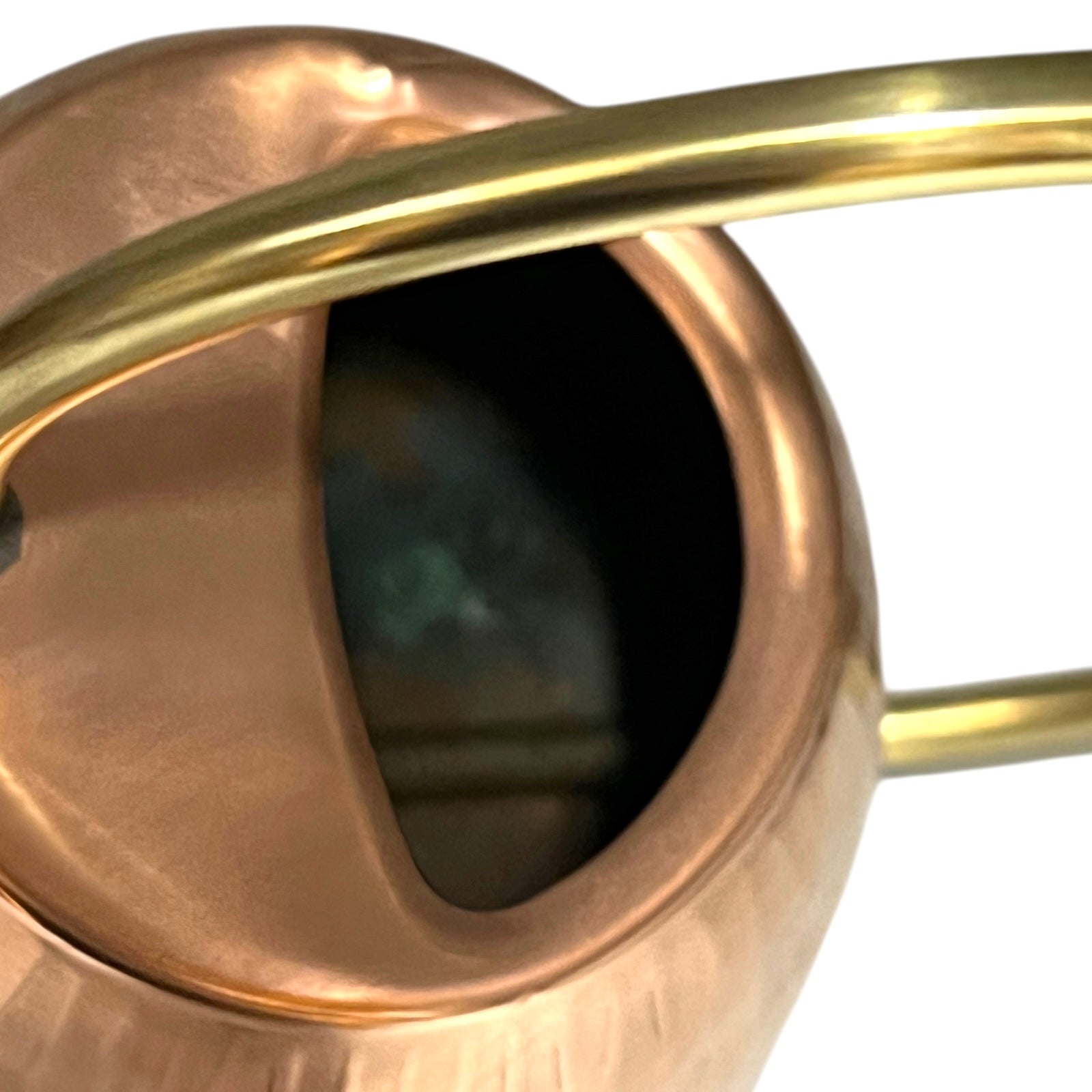 Close up of copper and brass watering can on a white background