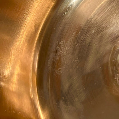 Close up of a French copper bathroom basin on a white background