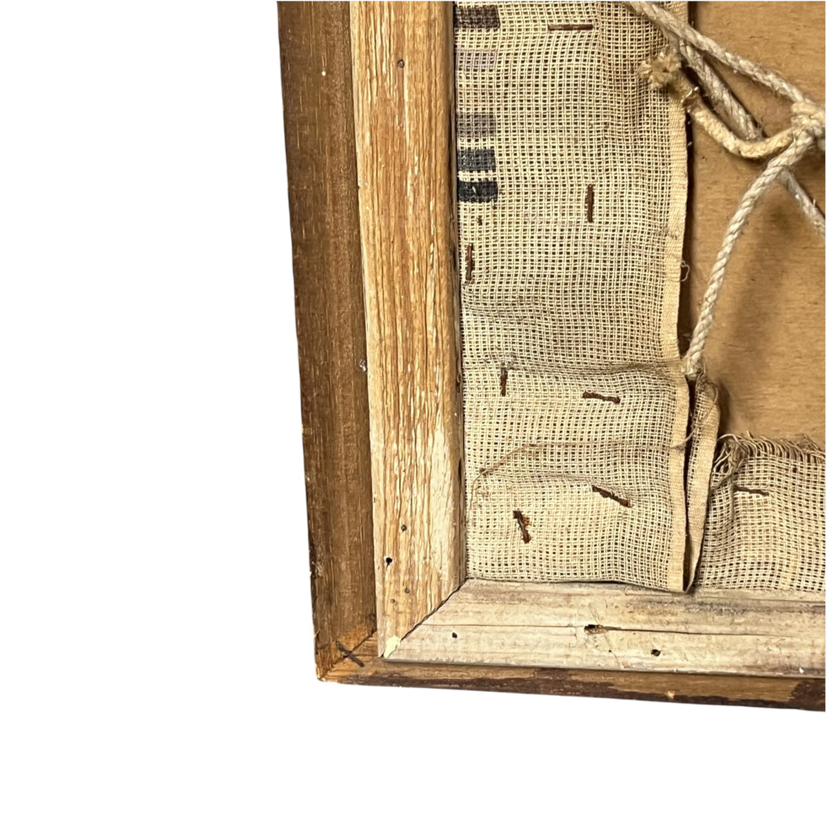 Close-up detail of the back corner of a rustic wooden framed canvas, showing the natural wood frame, burlap fabric, and hanging rope against a white background.