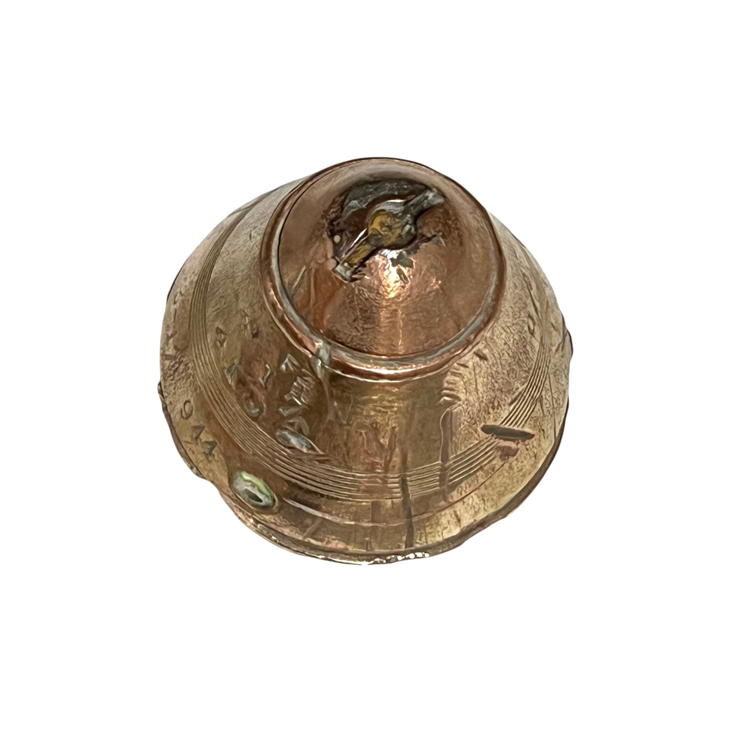 WW1 brass fuse paperweight with markings from use on a white background
