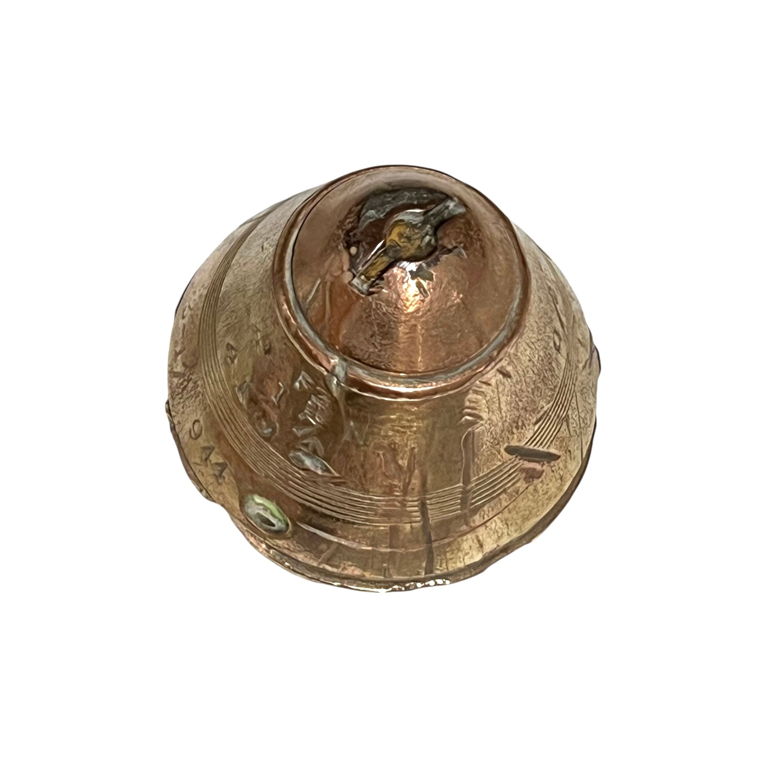 WW1 brass fuse paperweight with markings from use on a white background