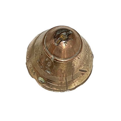 WW1 brass fuse paperweight with markings from use on a white background