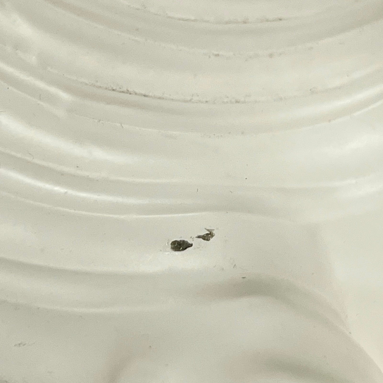 Close up of a Vintage-style light fixture with frosted glass shade on a white background