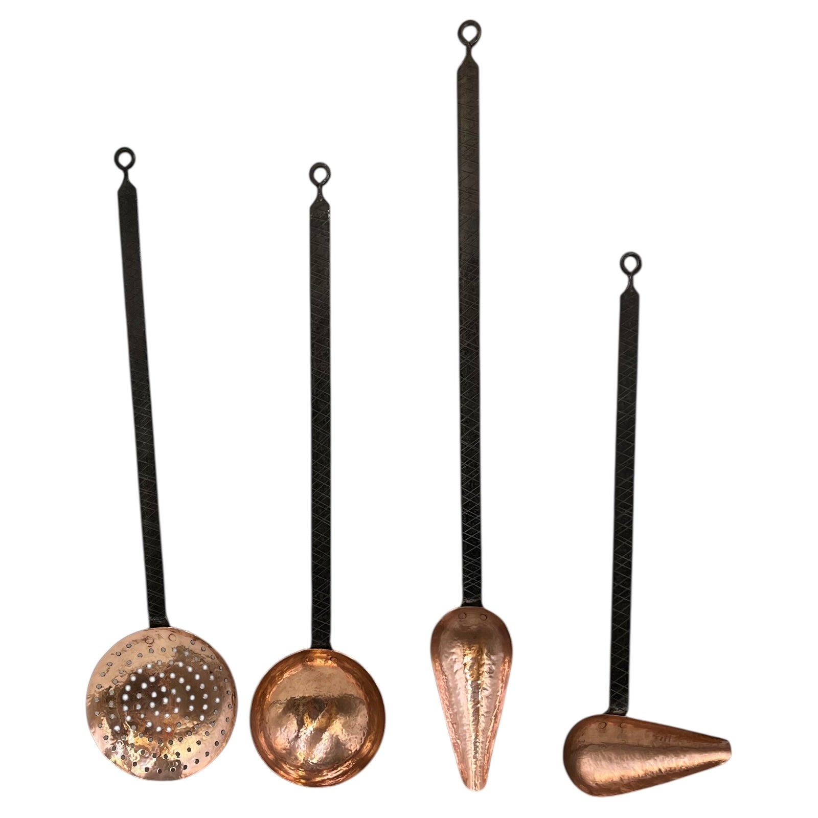 Set of four copper hanging tools with black strings on a white background